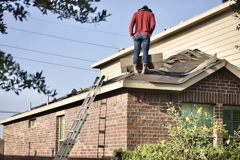 Professional roofer working on a residential roof in Mansefield
